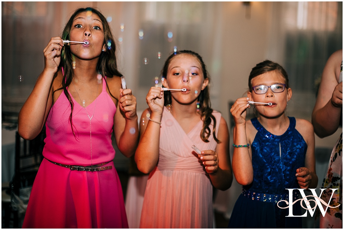 Beautiful girls blowing bubbles at a wedding