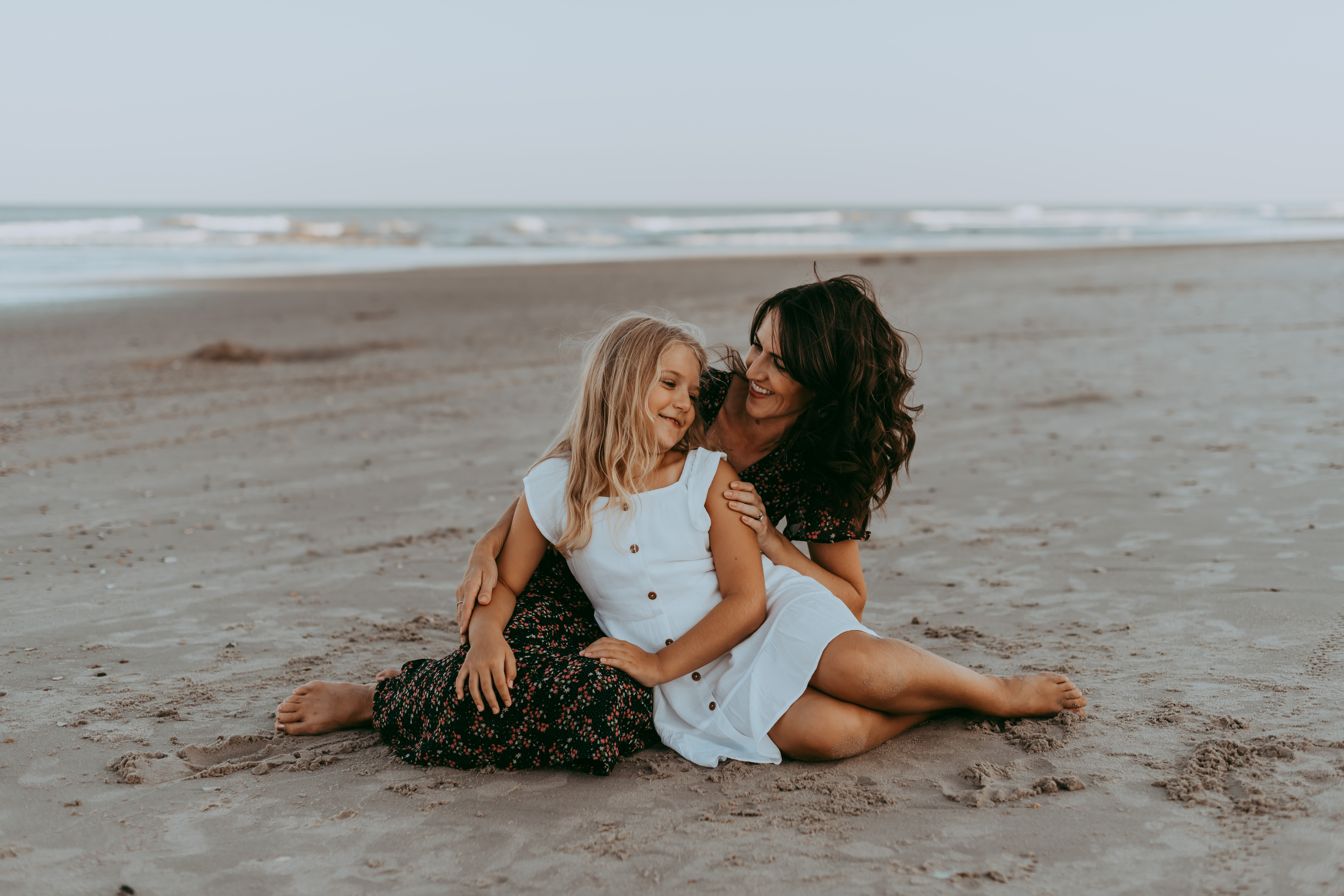  Mom and daughter sitting on the beach Family Photo Sessions by Laura Walter Photography