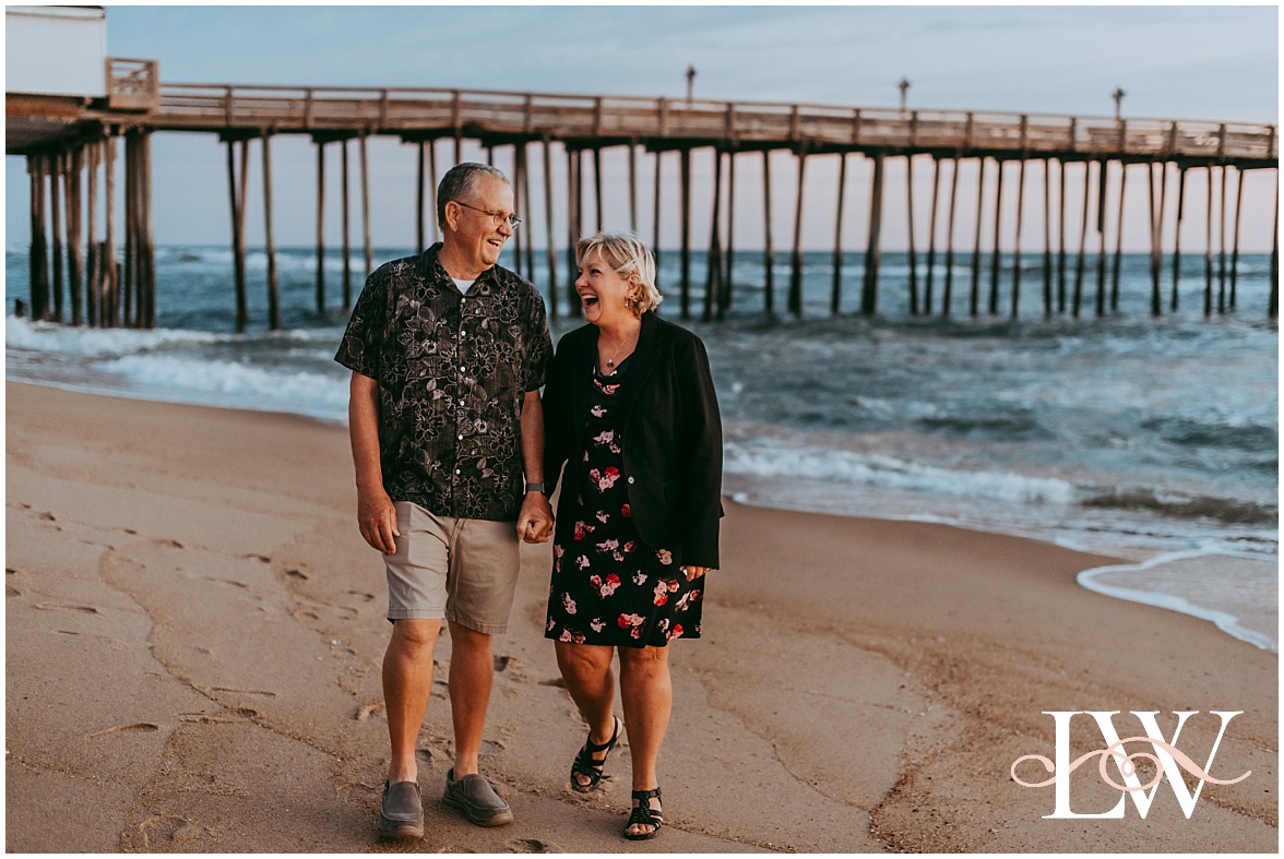 Kitty Hawk Couple walking holding hand laughing on the beach